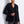 Load image into Gallery viewer, Woman wearing a black blazer and gray pants against a white wall
