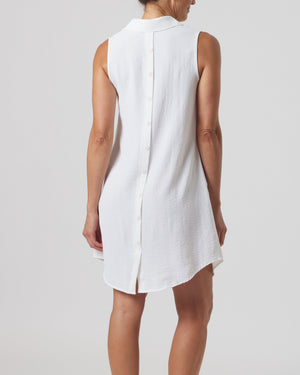 White sleeveless dress worn by a person on a plain background