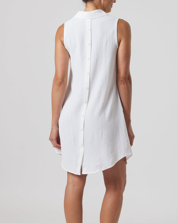 White sleeveless dress worn by a person on a plain background