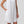 Load image into Gallery viewer, Woman wearing a white sleeveless dress against a plain background

